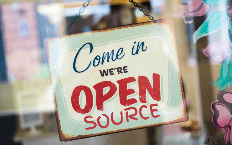 A storefront-style sign that reads: "Come in; we are open source" — image source: venturebeat.com.